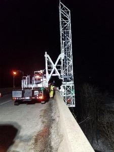 Equipment to install conduit along bridge