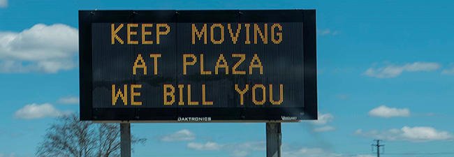 Digital matrix sign reading "Keep moving at plaza. We bill you."