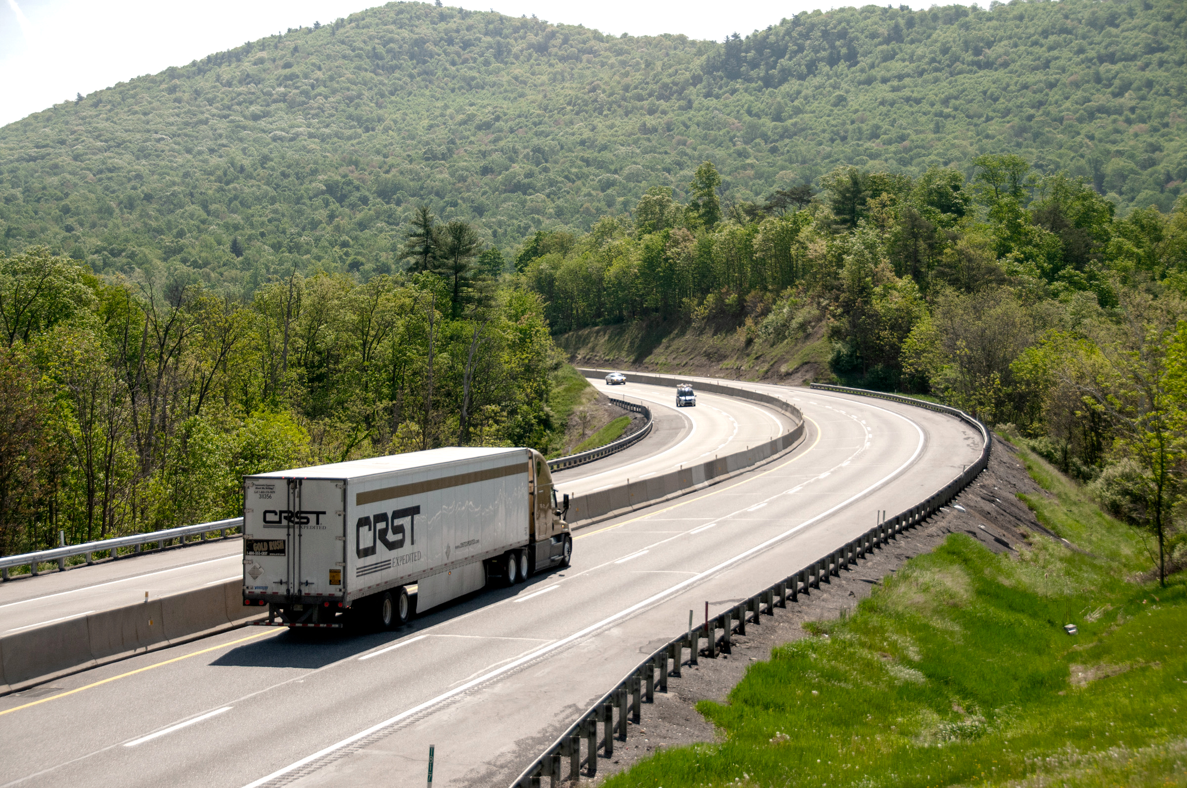 Truck on PA Turnpike curving through mountains