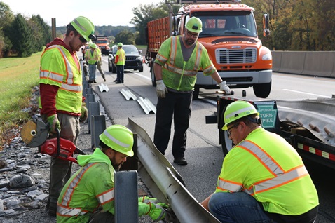 work zone Workers repairing guard rail
