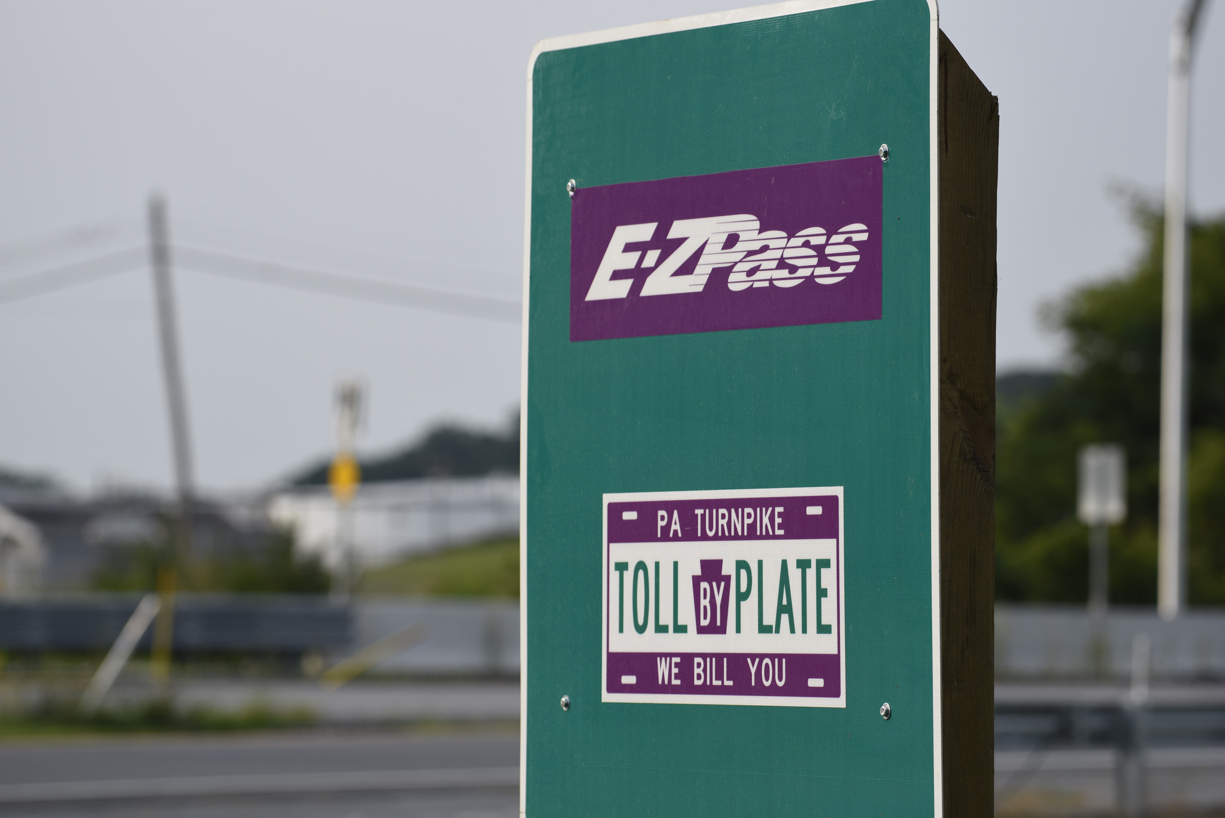 Road sign displaying "E-ZPass" and "Toll By Plate"