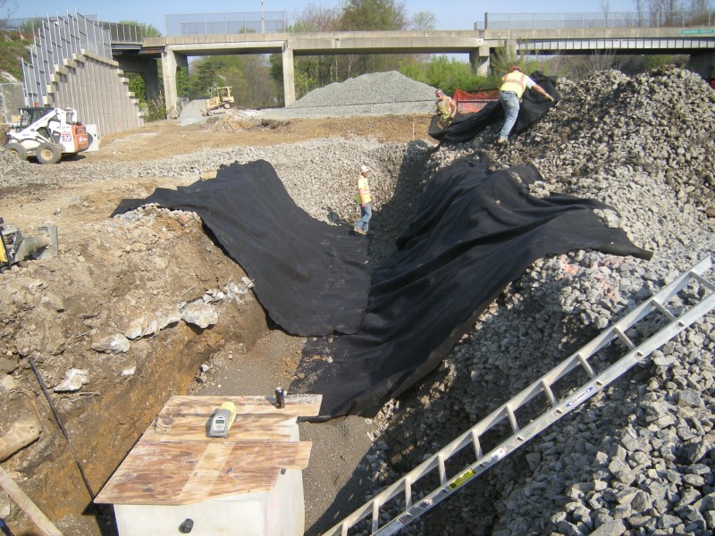 May 2015 - Abutment 1 Placing Geotextile Between Pipe Backfill and Structure Backfill